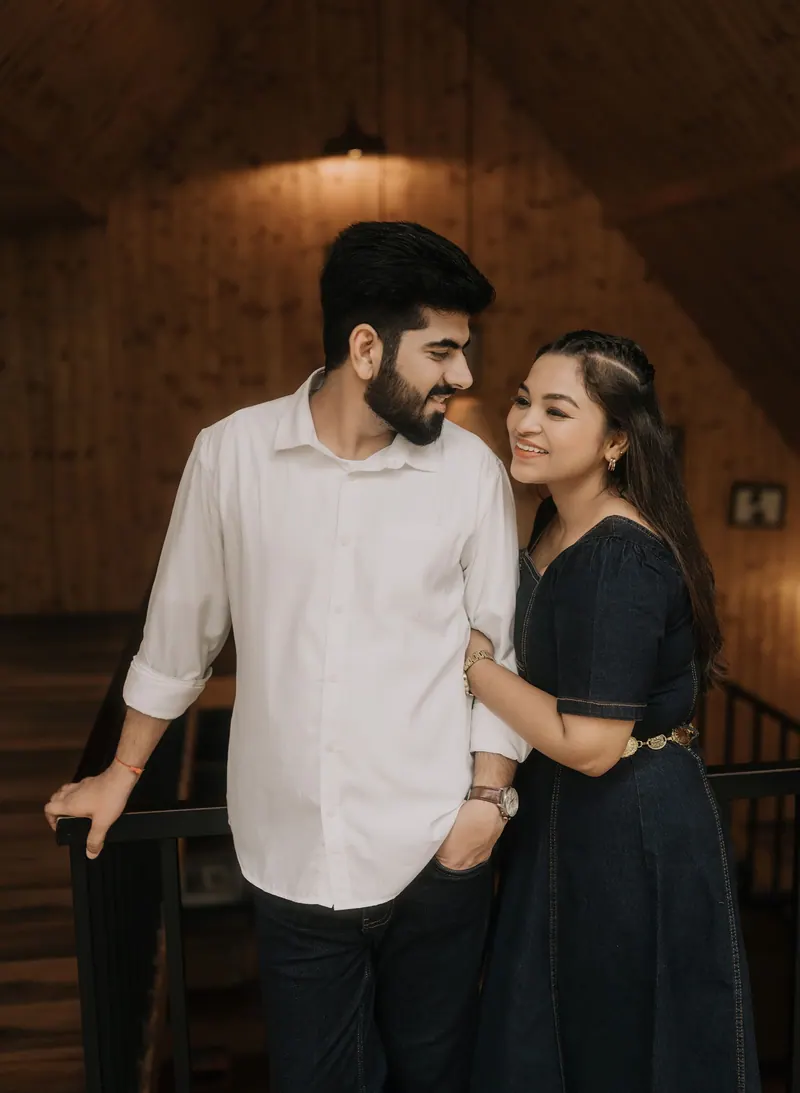 Couple standing together inside a wooden cabin