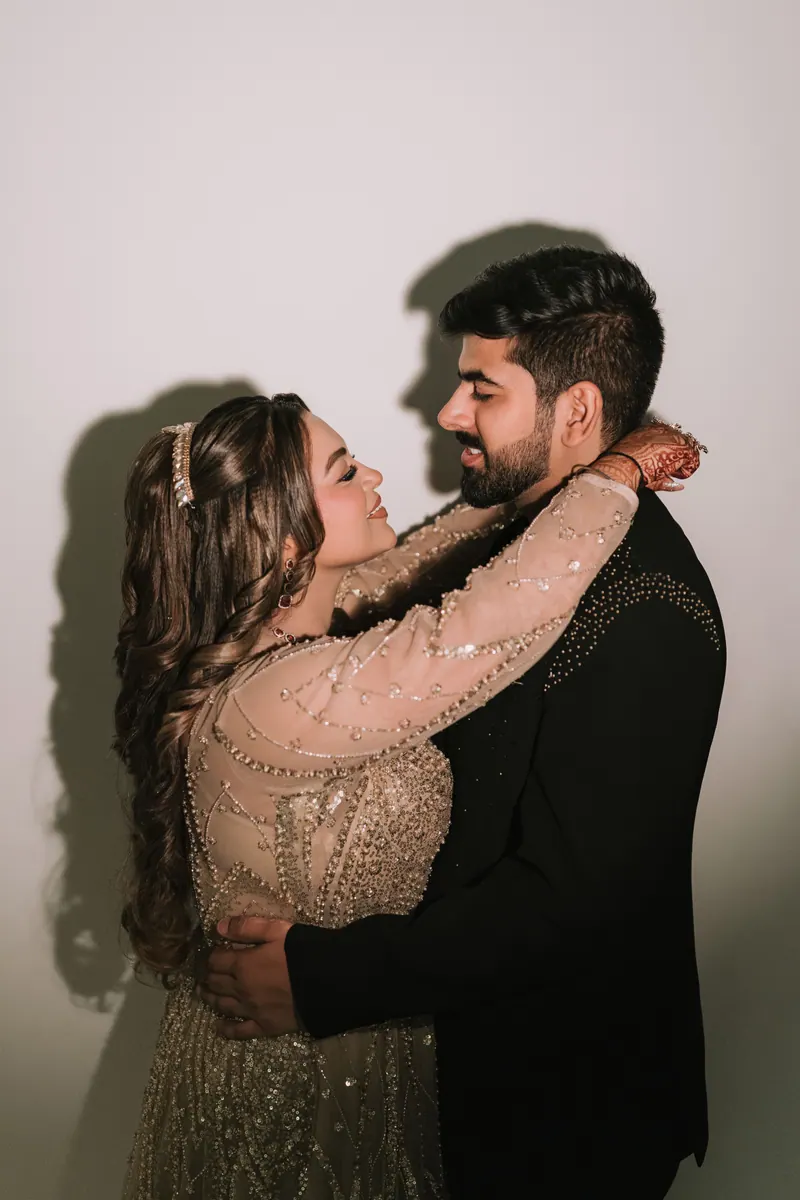 Groom embracing the laughing bride during a reception portrait